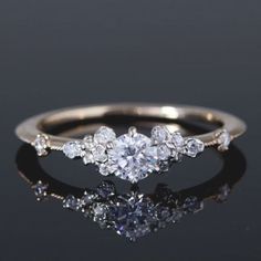 a three stone diamond ring on a black surface