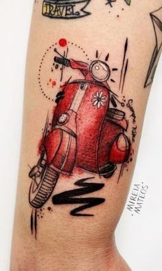 a red scooter tattoo on the arm