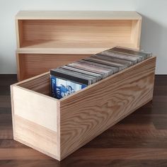 a wooden storage box with cd's in it