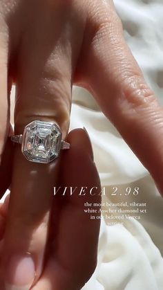 a woman's hand holding an engagement ring in front of her face and the words wed 2058 on it