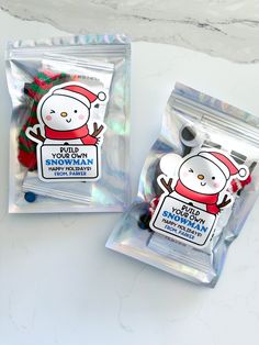 two bags of gummy bears in the shape of snowman and santa clauss