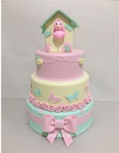 a three tiered cake with pink and blue decorations