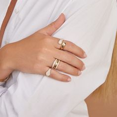 a woman's hand with two rings on it