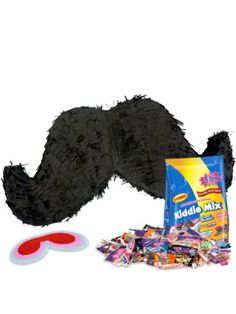 a fake moustache is laying on the ground next to candy