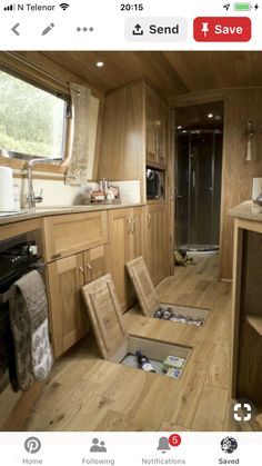 the inside of a motor home with wood flooring and cabinets, including an open sink