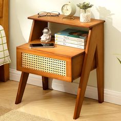 a small wooden table with books and glasses on it