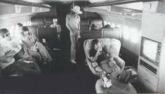 black and white photo of people sitting in an airplane