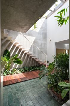 the inside of a house with plants and stairs