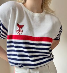 This stunning short-sleeved sweater from the 60s fits the old-money aesthetic so well! It has rounded sleeves and a gorgeous embroidered life ring.  - Perfect vintage condition  - Navy, red and a soft white  - Made in Canada  - 100% Acrylic  Size : women's M ( tagged a vintage size Large)  ~ Measurements ~  Length : 23.5 Shoulder to shoulder : 20 Bust : 40 Waist : 38 Lower Waist  Sleeve Inseam :28 (stretches to 42) * in inches  * colour may differ on different monitors ~ General information ~ * Nautical Cotton Sweater With Crew Neck, Nautical Cotton Crew Neck Sweater, White Vintage Summer Sweater, Nautical Outfit Women, Old Money Boat, 60s Fits, Marine Aesthetic, Nautical Outfits, Etiquette Vintage