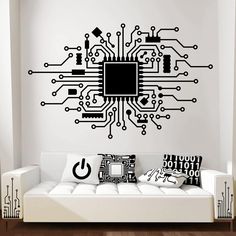 a living room with a white couch and black computer circuit board wall decal