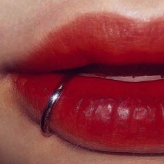 a woman's lips with red lipstick on them