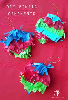 three pieces of paper that have been made into ornaments on a red surface with the words diy pinata ornaments