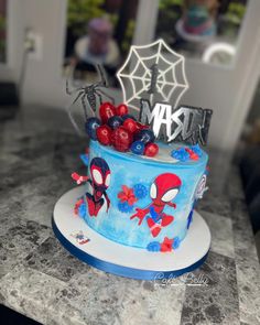 a spiderman themed cake on a table