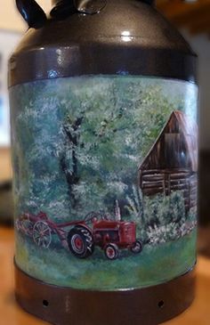 an old fashioned jug with a painting on it