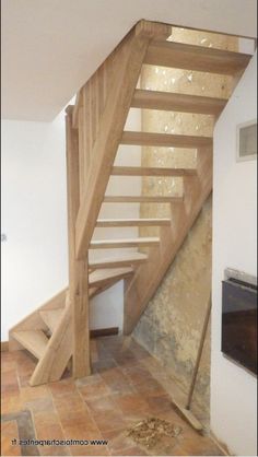 a wooden stair case in an unfinished room