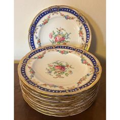 a stack of plates sitting on top of a wooden table