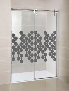 a glass shower door with an abstract design on the side and bottom panel in grey