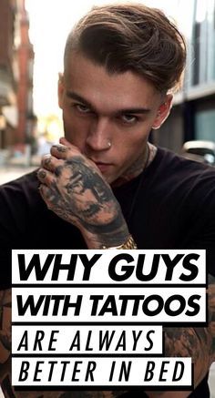 a man with tattoos is holding his hand to his face and looking at the camera