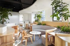 an office with circular seating and plants in the center