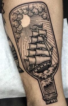 a ship in a bottle tattoo on the leg