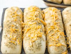 baked bread with cheese and herbs on a baking sheet, ready to go into the oven