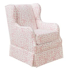 a pink and white chair with red spots on it