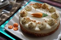 a cake with icing and carrots on a plate