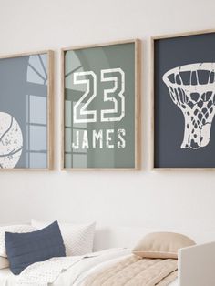 three framed sports pictures hang on the wall above a bed