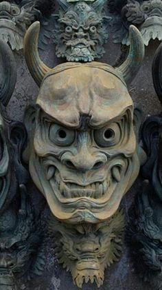 a close up of a mask on a building