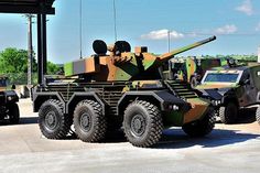 an army vehicle is parked in front of other vehicles