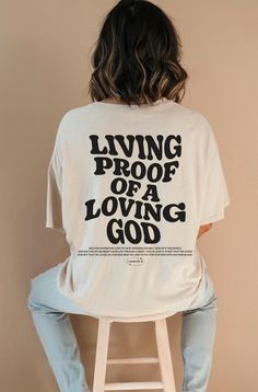 Introducing our new "Living Proof of a Loving God " t-shirt, a perfect expression of faith and style. This Christian shirt features a timeless design and a powerful message. This shirt is not only a fashionable choice but also a meaningful one. It serves as a reminder of the saving grace of Jesus Christ and the hope and redemption that comes with it. It's a great way to boldly express your faith and share your beliefs with others! ⁑ F U N ⁑ F A C T S ⁑ ☼ Unisex Adult Sizes ☼ 100% Cotton ☼ Washer Lili Art, Bible Verse T Shirt, Christian Clothing Brand, Bible Verse Tees, Aesthetic Christian, Christian Shirts Designs, Gospel Quotes, Christian Streetwear, Loving God