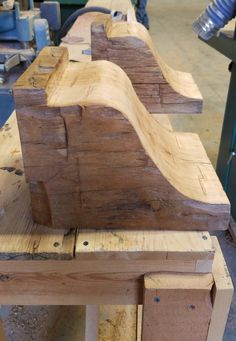 a wooden bench made out of wood planks in a shop with other work tools