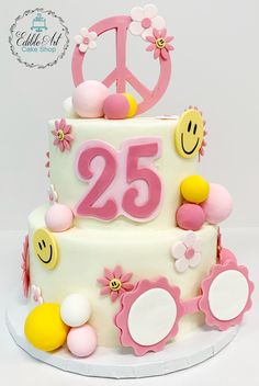 a white cake with pink and yellow decorations