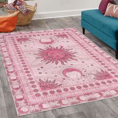 a living room with a blue couch and pink rug on the floor next to a chair