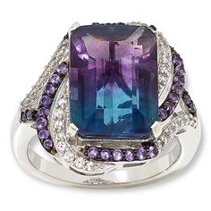 Colleen Lopez Sterling Silver Bi-Color Fluorite and Multigem Ring  Flaunt your unique style when you accessorize with this captivating ring design. The sterling silver piece features a natural, bi-color fluorite stone surrounded by complementary purple amethyst and the diamond-like sparkle of white zircons. The result is an elegant, distinctive piece you'll be wearing for many years to come!       Approx. 7/16"L x 7/16"W; shank 3/16"W     Stamped .925     Ring has emerald-cut, bi-color fluorite stone prong set in center of swirl design     Swirl-style frame and split shoulders lined with round white zircons and purple amethyst stones     Finished undergallery   Stone Information       All sizes and weights approximate     Total Carat Weight: 9.04ct     Bi-Color (Green/Purple) Fluorite - Em