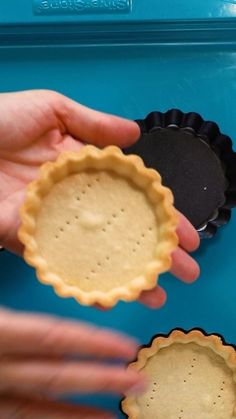 two pie crusts being held in front of each other