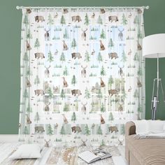 a living room with green walls and white curtains featuring deer, pine trees, and snowflakes