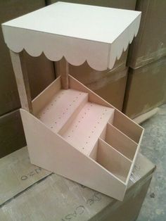 an open box sitting on top of cardboard boxes with scalloped trimmings