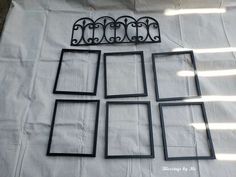 four black frames sitting on top of a white sheet