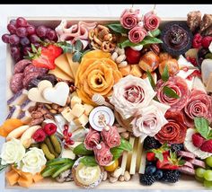 a tray filled with lots of different types of fruit and veggies on top of each other