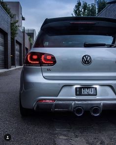 the rear end of a silver volkswagen car