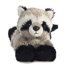 a stuffed panda bear with black and white fur on it's face sitting down