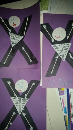 three pieces of paper cut out to look like skeletons and crossbones on purple background