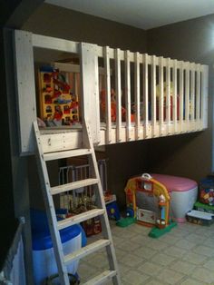 there is a bunk bed with a ladder next to it and toys on the floor