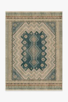 a blue and beige area rug with an intricate design on the center, in front of a white background