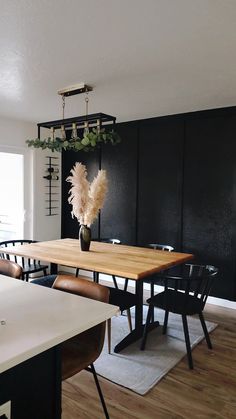 a dining room with black walls and wooden tables