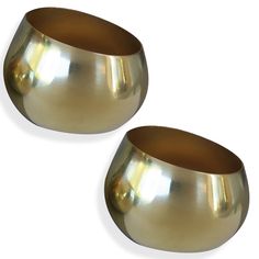 two shiny metal bowls sitting next to each other