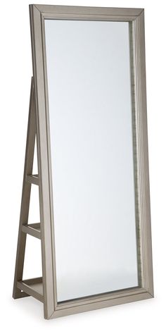 a silver framed mirror sitting on top of a wooden stand