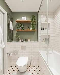 a white toilet sitting in a bathroom next to a bath tub and shower head mounted on a wooden shelf