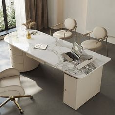 a white marble table with chairs and a laptop on it in front of a large window